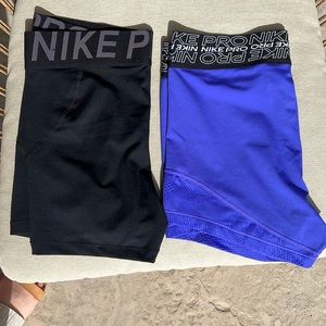 Nike Pros. 2 total - 1 black, 1 blue with crisscross band. Both Size L